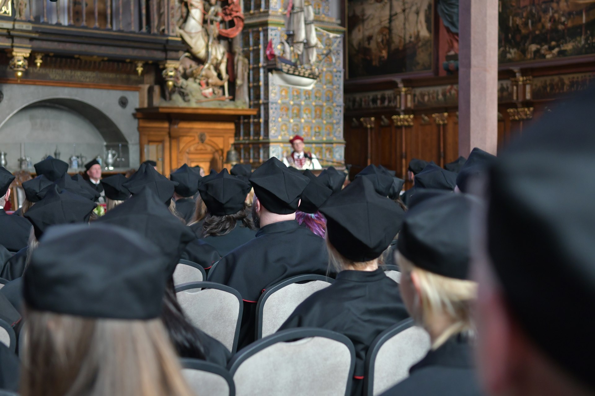 a large group of people in graduation caps and gowns